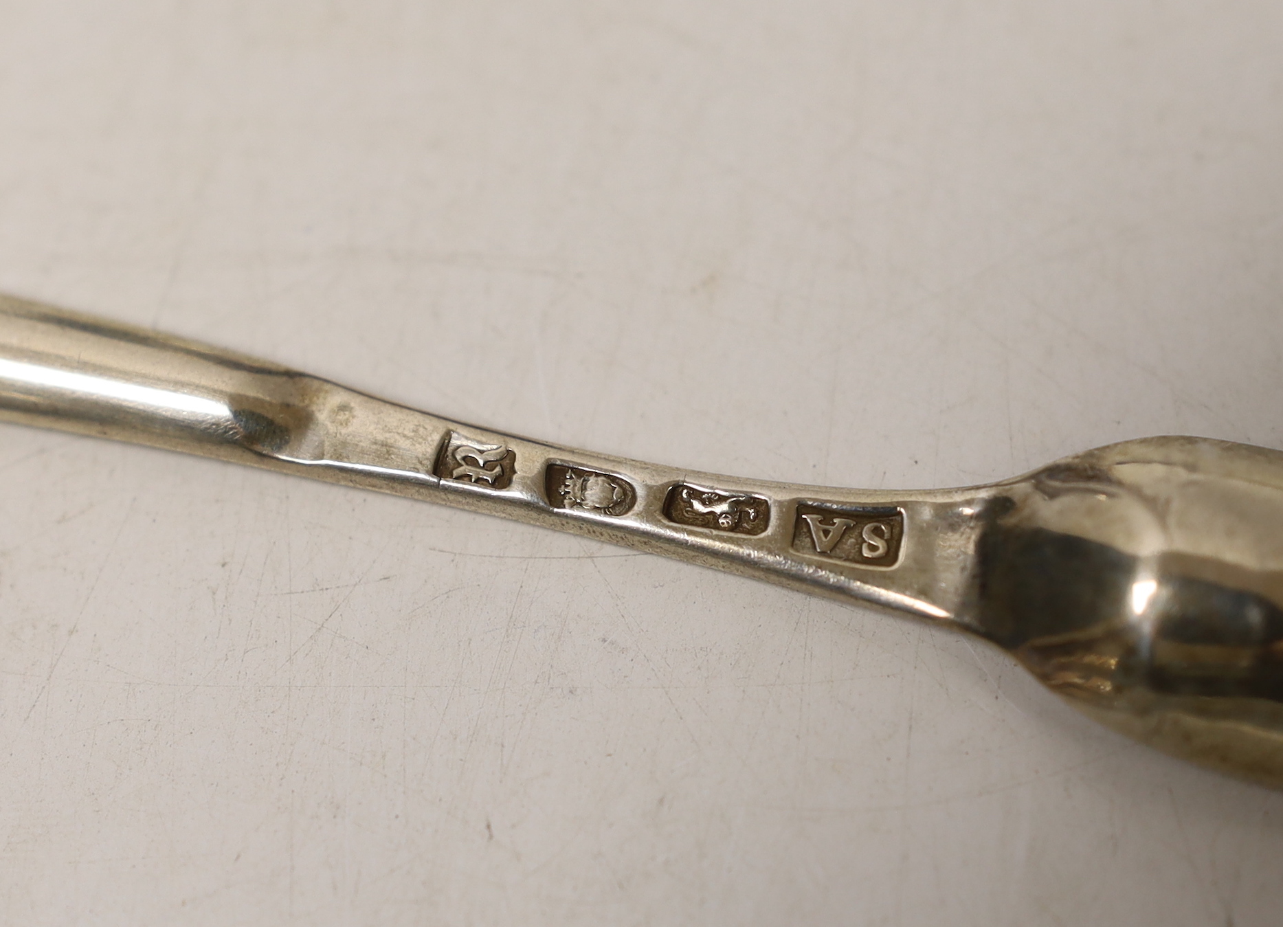 A George III silver marrow scoop, Stephen Adam, London, 1772, 21.5cm, a pair of mid to late 18th century silver sugar nips, a later silver mustard and pair of silver sugar tongs.